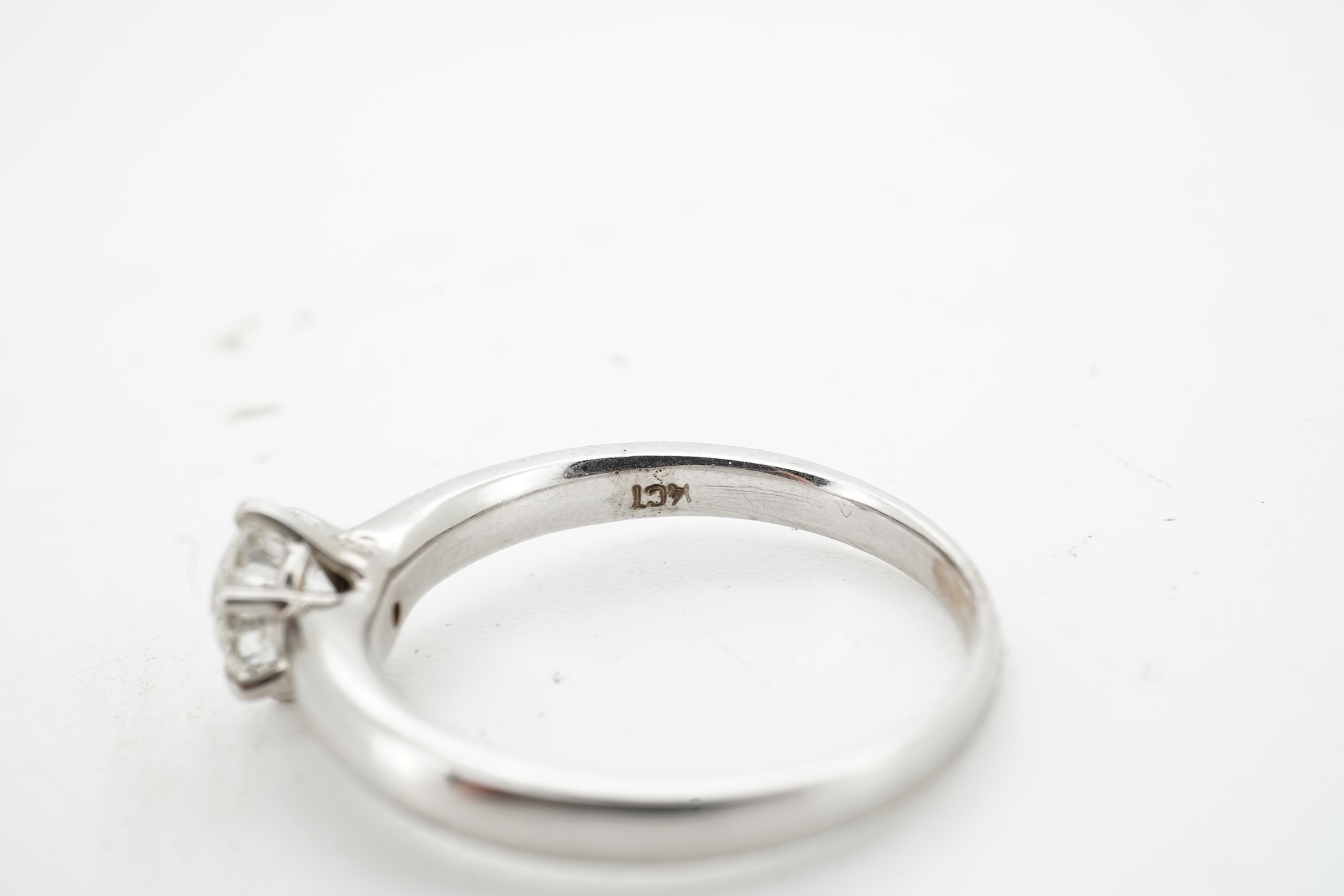 A diamond ring, claw-set with a brilliant-cut diamond weighing approximately 0.80 carats, mounted in white gold, size M, stamped 14K, gross weight approximately 3 grams